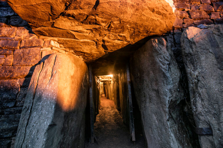a passageway surrounded by rocks Newgrange Visitor Center