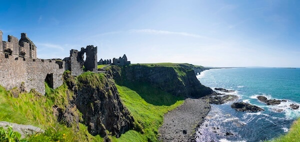 a castle on the edge of a cliff coastal causeway route