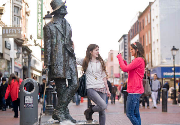 two girls standing here a statue Dublin's literature festival