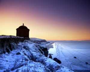 a building on a clifftop at sunset January in Ireland