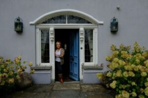 a woman standing by a door Green Door Tours